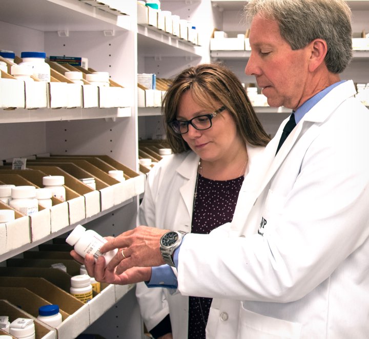 Pharmacists pulling medication from the shelf